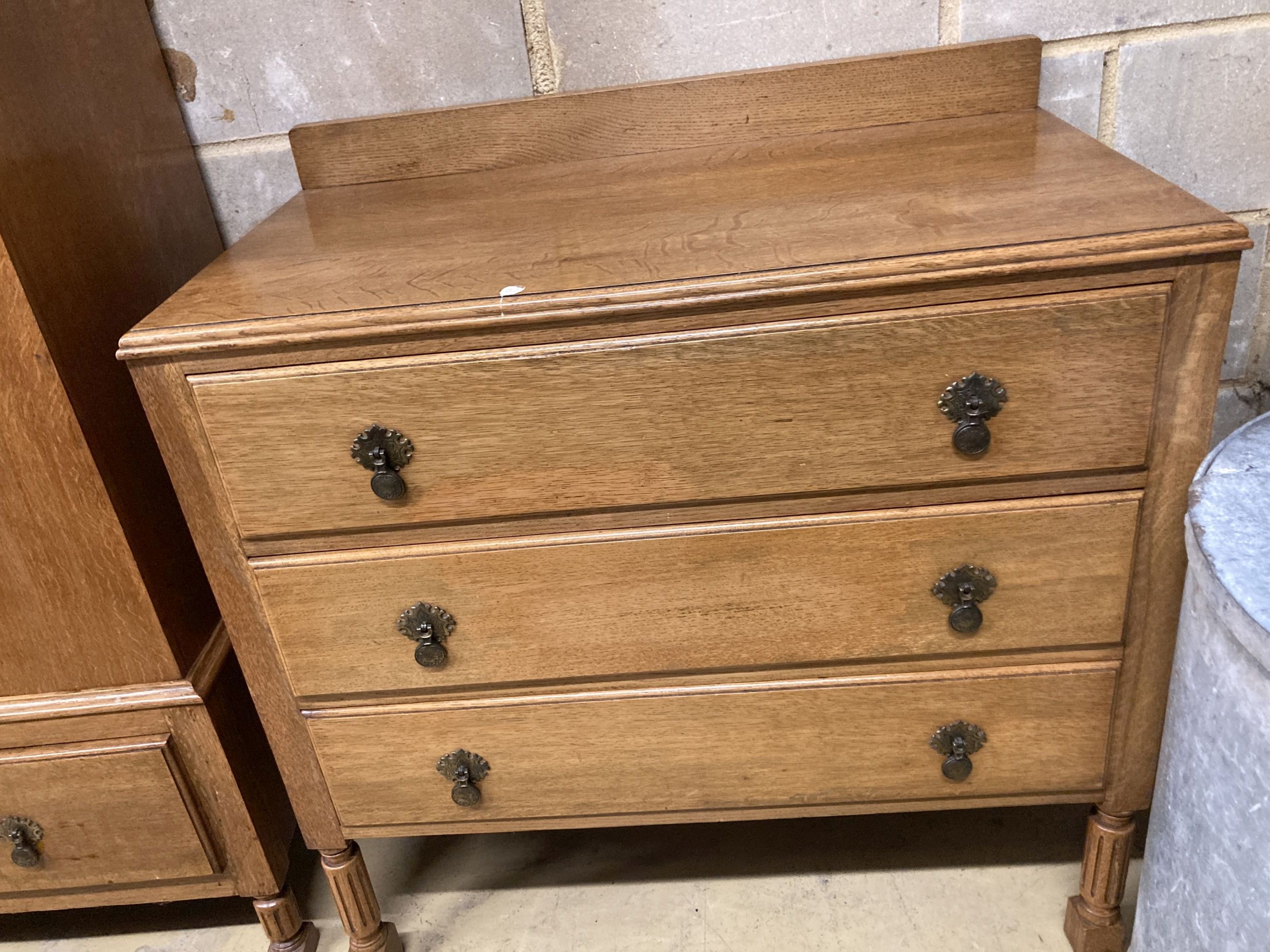 An early 20th century inlaid oak three piece bedroom suite, wardrobe width 106cm, depth 43cm, height 193cm